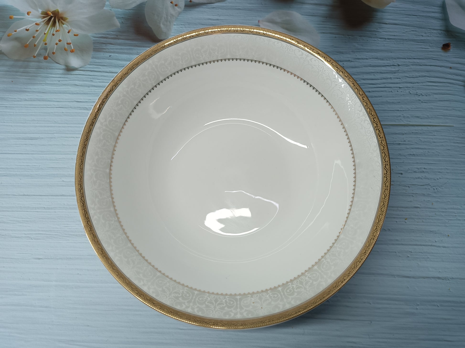 Large serving bowl in fine china with intricate golden and silver detailing, perfect for elegant dining and special occasions.