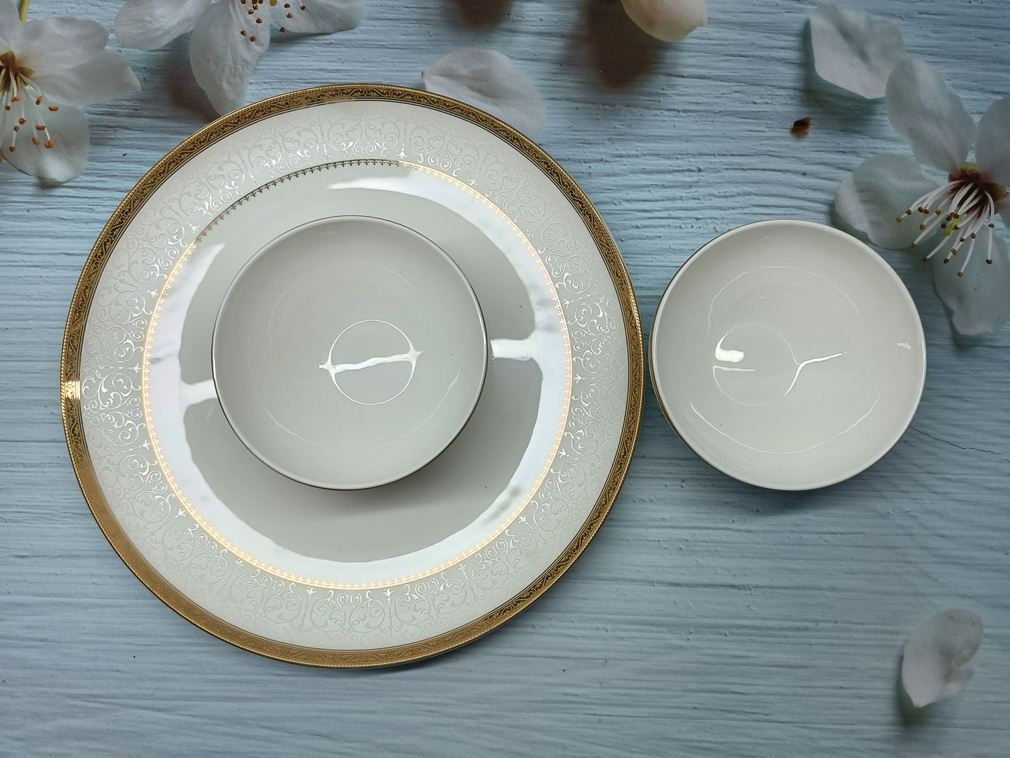 Plate and bowl set made from fine china with elegant golden and silver detailing, perfect for adding a touch of luxury to any dining table or special occasion.